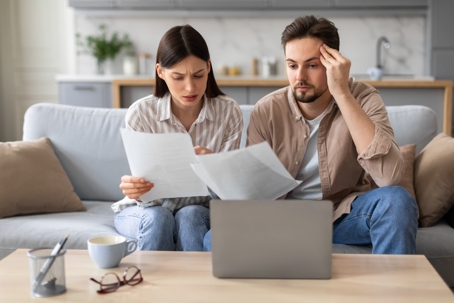 stressed couple reviewing documents