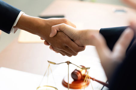 people shaking hands in law office